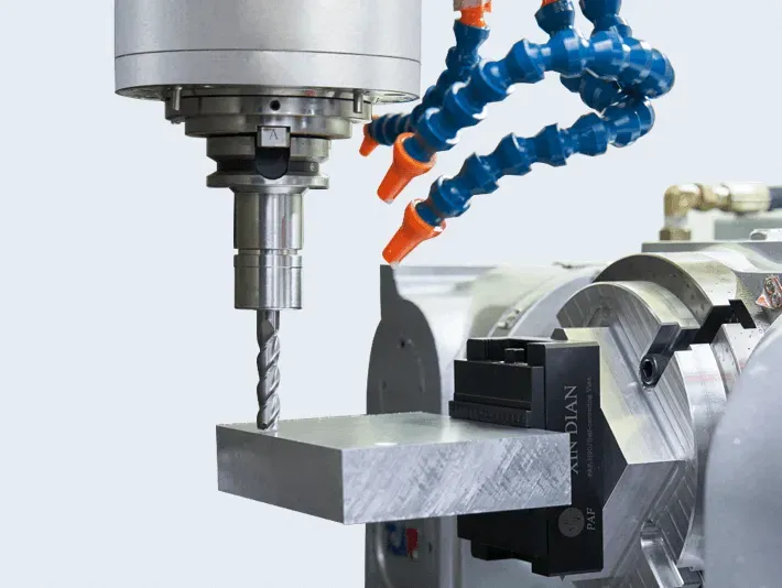CNC milling machine cutting a precision metal part